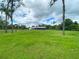 Open pasture with a rustic animal shelter in the background at 33931 Serene Dr, Punta Gorda, FL 33982