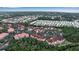 Aerial view of community, showing building exteriors, landscaping, and a lake at 4122 Central Sarasota Pkwy # 1914, Sarasota, FL 34238