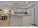 Kitchen features white cabinets and breakfast bar at 4122 Central Sarasota Pkwy # 1914, Sarasota, FL 34238