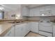 White kitchen with stainless steel appliances at 4122 Central Sarasota Pkwy # 1914, Sarasota, FL 34238