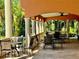 Covered patio with tables and chairs, perfect for relaxing at 4122 Central Sarasota Pkwy # 1914, Sarasota, FL 34238