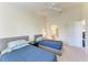 Bright bedroom with twin beds, nightstands, and access to a bathroom at 4366 Madeira Ct # 3356, Sarasota, FL 34233