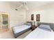 Guest bedroom with two twin beds and en-suite bathroom at 4366 Madeira Ct # 3356, Sarasota, FL 34233