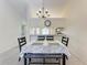 Bright dining room with chandelier and seating for four at 4366 Madeira Ct # 3356, Sarasota, FL 34233