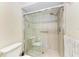 Walk-in shower with tiled walls and safety features at 4366 Madeira Ct # 3356, Sarasota, FL 34233