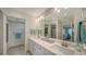 Double vanity bathroom features updated fixtures and a large mirror reflecting natural light at 4600 Gulf Of Mexico Dr # 206, Longboat Key, FL 34228