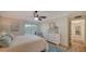 Bright bedroom features a ceiling fan, dresser, and access to a private balcony at 4600 Gulf Of Mexico Dr # 206, Longboat Key, FL 34228