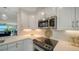 Modern kitchen with white cabinets, stainless steel appliances at 4600 Gulf Of Mexico Dr # 206, Longboat Key, FL 34228