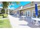 Community patio with tables and chairs for relaxing at 4600 Gulf Of Mexico Dr # 206, Longboat Key, FL 34228