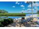 Relaxing waterfront patio with fire pit and seating at 4600 Gulf Of Mexico Dr # 206, Longboat Key, FL 34228