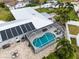 Aerial view of a home with a screened-in pool and solar panels at 4648 Orlando Cir, Bradenton, FL 34207