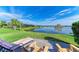 Enjoy lake views from this backyard patio with lounge chairs at 4716 Foxtail Dr, Parrish, FL 34219