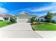 Single-story home with attached garage and well-manicured lawn at 4716 Foxtail Dr, Parrish, FL 34219