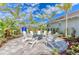 Community fire pit with white chairs on a paved patio at 4716 Foxtail Dr, Parrish, FL 34219