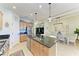 Modern kitchen with island, stainless steel appliances, and light wood cabinets at 4716 Foxtail Dr, Parrish, FL 34219