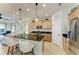 Modern kitchen with island, stainless steel appliances, and light wood cabinets at 4716 Foxtail Dr, Parrish, FL 34219