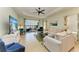Living room features a large TV and access to a patio at 4716 Foxtail Dr, Parrish, FL 34219