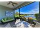 Relaxing screened lanai overlooking a lake with seating area at 4716 Foxtail Dr, Parrish, FL 34219