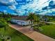 Home with a two-car garage and paved driveway at 4986 Antiquity Way, Sarasota, FL 34240