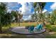 Relaxing backyard firepit area with teal chairs, perfect for outdoor gatherings at 4986 Antiquity Way, Sarasota, FL 34240