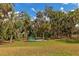 Serene backyard with firepit and lush landscaping, offering a private escape at 4986 Antiquity Way, Sarasota, FL 34240