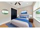 Comfortable bedroom with a queen bed and a view of the backyard at 4986 Antiquity Way, Sarasota, FL 34240