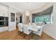 Elegant dining area with a white table and chairs, and a view to the backyard at 4986 Antiquity Way, Sarasota, FL 34240
