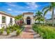 Landscaped entryway with brick pavers and palm trees at 4986 Antiquity Way, Sarasota, FL 34240