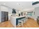 Spacious kitchen with white cabinets, marble island, and stainless steel appliances at 4986 Antiquity Way, Sarasota, FL 34240