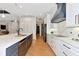 Modern kitchen with white cabinets, blue island, and marble countertops at 4986 Antiquity Way, Sarasota, FL 34240