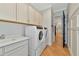 Laundry room with washer, dryer, cabinets, and countertop at 4986 Antiquity Way, Sarasota, FL 34240