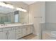 Bathroom with double vanity, quartz countertop and a large mirror at 4986 Antiquity Way, Sarasota, FL 34240