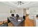 Home office with wood floors, desk, and built-in shelving at 4986 Antiquity Way, Sarasota, FL 34240