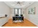 Bright office features wood floors, built-in shelving and large windows at 4986 Antiquity Way, Sarasota, FL 34240