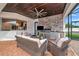 Outdoor kitchen with built-in grill and seating area at 4986 Antiquity Way, Sarasota, FL 34240