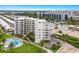 Aerial view of condo building with pool and beach access at 5830 Midnight Pass Rd # 502, Sarasota, FL 34242