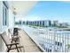 Long balcony with multiple chairs and ocean view at 5830 Midnight Pass Rd # 502, Sarasota, FL 34242