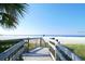 Beach access walkway leading to the sandy shore at 5830 Midnight Pass Rd # 502, Sarasota, FL 34242