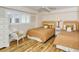 Guest bedroom with two twin beds and light wood floors at 5830 Midnight Pass Rd # 502, Sarasota, FL 34242