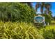 Jamaica Royale community entrance with lush landscaping at 5830 Midnight Pass Rd # 502, Sarasota, FL 34242