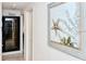 Hallway with wine storage and coastal-themed art at 5830 Midnight Pass Rd # 502, Sarasota, FL 34242