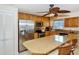 Island kitchen with stainless steel appliances and wood cabinets at 5830 Midnight Pass Rd # 502, Sarasota, FL 34242