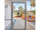 Ornate screen door with heron design, offering a view of the walkway and landscaping at 605 Coconut Crescent, Nokomis, FL 34275