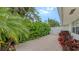 Landscaped backyard patio with brick pavers and lush greenery at 605 Wild Turkey Ln, Sarasota, FL 34236