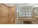 Bathroom with walk-in shower, vanity, and window with shutters at 605 Wild Turkey Ln, Sarasota, FL 34236
