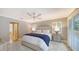 Main bedroom with king bed, ceiling fan, and window shutters at 605 Wild Turkey Ln, Sarasota, FL 34236