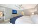 Main bedroom with king bed, large TV, and ceiling fan at 605 Wild Turkey Ln, Sarasota, FL 34236
