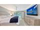 Main bedroom with king bed, large TV, and pool access at 605 Wild Turkey Ln, Sarasota, FL 34236
