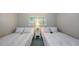 Bedroom with two twin beds and window at 605 Wild Turkey Ln, Sarasota, FL 34236