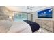 Main bedroom with king bed, large TV, and pool access at 605 Wild Turkey Ln, Sarasota, FL 34236